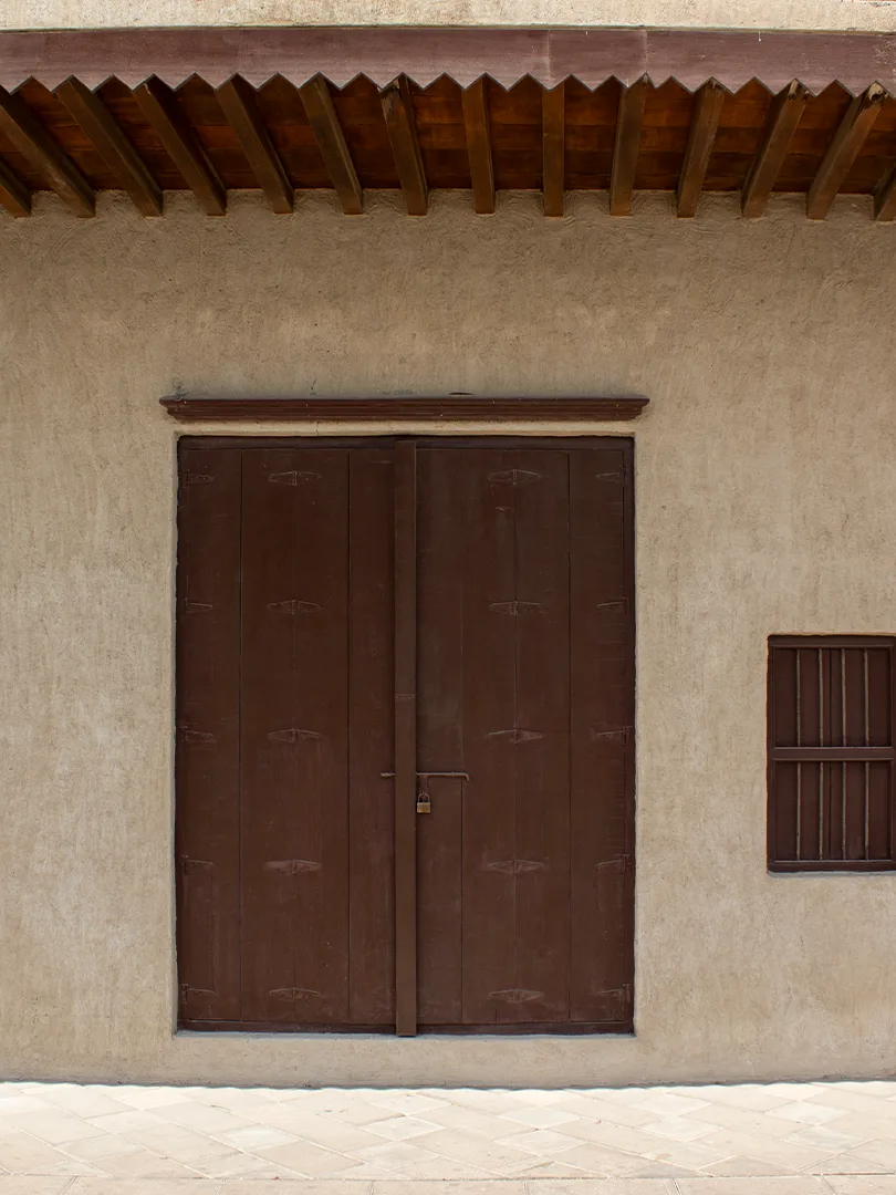 Coral-stone wall and wooden door, Al Fahidi